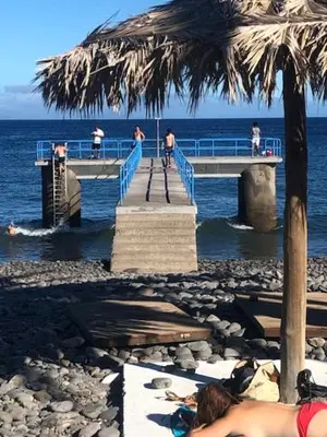 a group of people walking on a pier over the water at Casa Dona Teresa in Santa Cruz