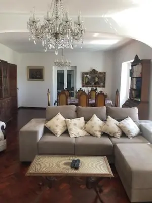 a living room with a couch and a chandelier at Casa Dona Teresa in Santa Cruz