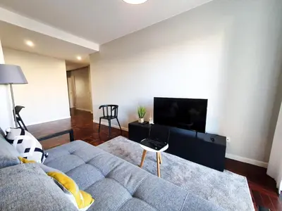 a living room with a couch and a tv at Santa Luzia's Pearl I C - One Bedroom Apartment in Funchal