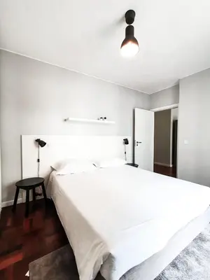 a bedroom with a large white bed and a lamp at Santa Luzia's Pearl I C - One Bedroom Apartment in Funchal