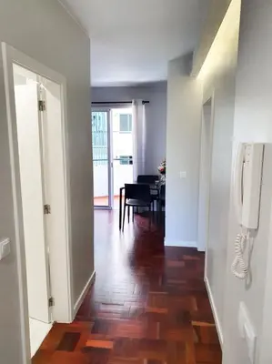 a hallway with a dining room and a room with a table at Santa Luzia's Pearl I C - One Bedroom Apartment in Funchal