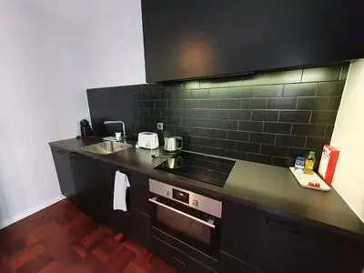 a kitchen with a black counter and a sink at Santa Luzia's Pearl I C - One Bedroom Apartment in Funchal