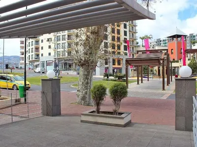 a pavilion with trees in a city with buildings at Apartamento Lugar do Mar ,wonderful sea view in Funchal