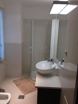 a bathroom with a sink and a shower at Apartamento Lugar do Mar ,wonderful sea view in Funchal