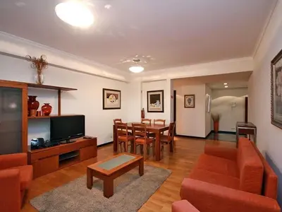a living room with a table and a dining room at Apartamento Lugar do Mar ,wonderful sea view in Funchal