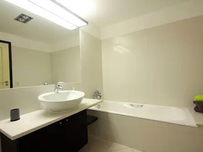 a white bathroom with a sink and a bath tub at Apartamento Lugar do Mar ,wonderful sea view in Funchal