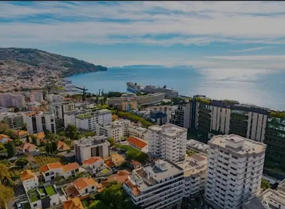 an aerial view of a city and a body of water at City Nest in Funchal