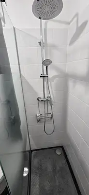 a bathroom with a shower with a glass door at City Nest in Funchal