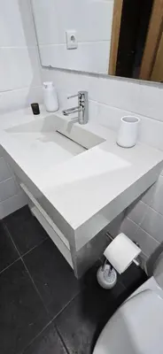a white bathroom with a sink and a toilet at City Nest in Funchal