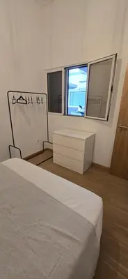 a bedroom with a white bed and a window at City Nest in Funchal