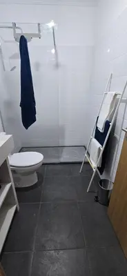 a bathroom with a toilet and a glass shower at City Nest in Funchal