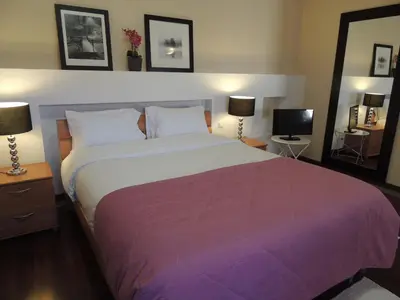 a bedroom with a large bed with a purple blanket at Studio Flat with Pool in Funchal