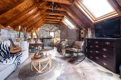 a living room with a couch and a tv at Cabana da Quinta Girassol by YMR in Ponta do Sol
