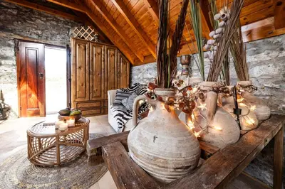 a room with several large vases on a table at Cabana da Quinta Girassol by YMR in Ponta do Sol