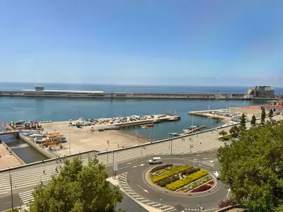 a road in a harbor with a marina with boats at Center Marina view Silver Studio in Funchal