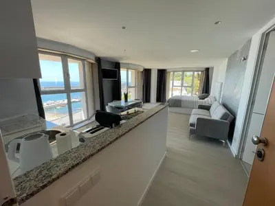 a kitchen and living room with a view of the ocean at Center Marina view Silver Studio in Funchal