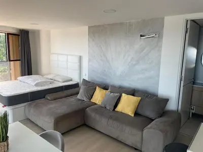 a living room with a couch and a bed at Center Marina view Silver Studio in Funchal