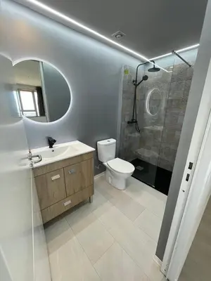 a bathroom with a toilet and a sink and a shower at Center Marina view Silver Studio in Funchal