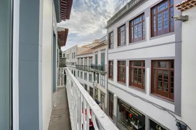 a balcony with a view of a building at Mouraria Studios in Funchal
