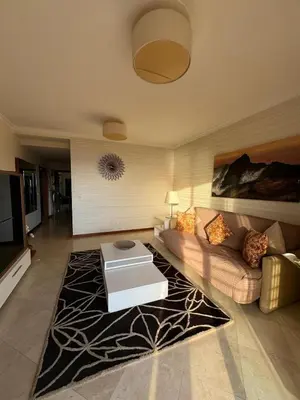 a living room with a couch and a table at Fórum Plaza III in Funchal
