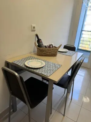 a table with a bottle of wine and a basket on it at Fórum Plaza III in Funchal