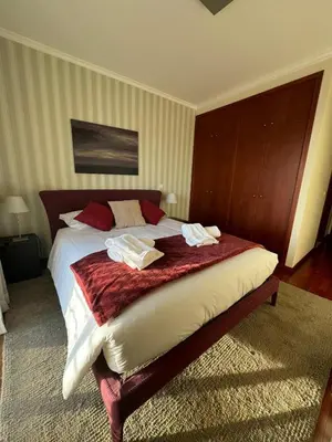 a bedroom with a bed with two towels on it at Fórum Plaza III in Funchal