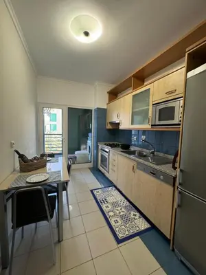 a kitchen with a table and a dining room at Fórum Plaza III in Funchal