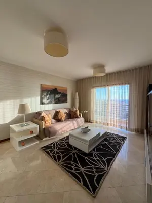 a living room with a couch and a table at Fórum Plaza III in Funchal