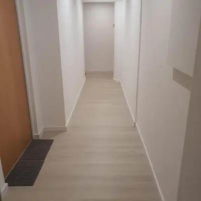 a hallway with white walls and a wooden floor at Center Marina view Yellow Studio in Funchal