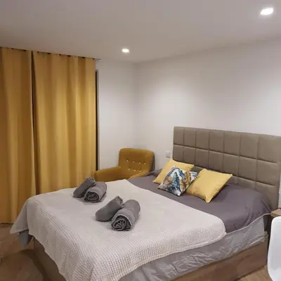 a bedroom with a large bed with towels on it at Center Marina view Yellow Studio in Funchal