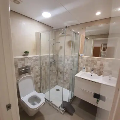 a bathroom with a shower and a toilet and a sink at Center Marina view Yellow Studio in Funchal