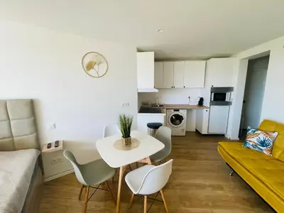 a living room with a table and chairs and a couch at Center Marina view Yellow Studio in Funchal