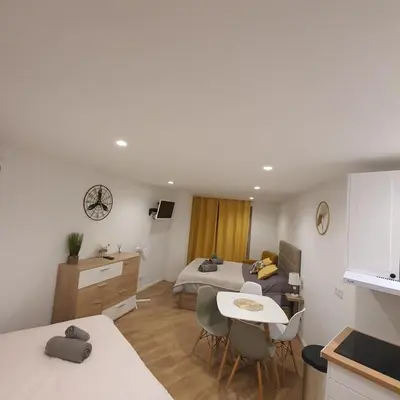 a bedroom with a bed and a table and chairs at Center Marina view Yellow Studio in Funchal