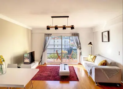 a living room with a couch and a table at VeBella Abegoaria in Caniço