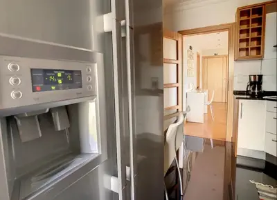 a kitchen with a stainless steel refrigerator in a room at VeBella Abegoaria in Caniço