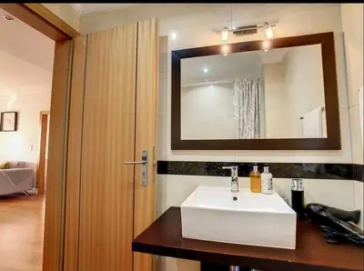 a bathroom with a white sink and a mirror at VeBella Abegoaria in Caniço