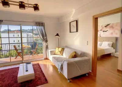 a living room with a couch and a bed at VeBella Abegoaria in Caniço