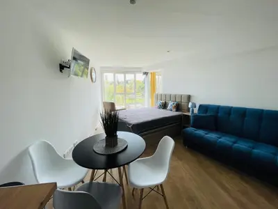 a living room with a couch and a table and chairs at Center Marina view Purple Studio in Funchal