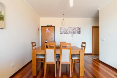 a dining room with a wooden table and chairs at Garajau View Apartment by Holiday Rental Madeira in Caniço