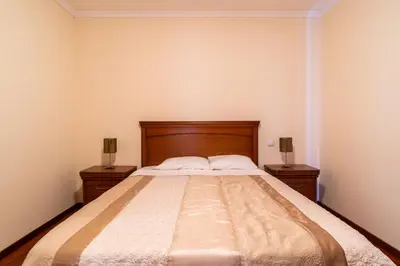 a bedroom with a large bed with two night stands at Garajau View Apartment by Holiday Rental Madeira in Caniço