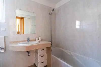 a bathroom with a sink and a bath tub at Garajau View Apartment by Holiday Rental Madeira in Caniço
