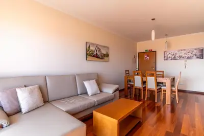 a living room with a couch and a table at Garajau View Apartment by Holiday Rental Madeira in Caniço