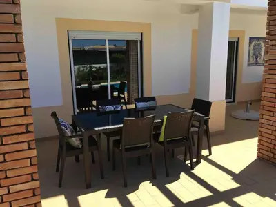 a dining room with a table and chairs at Praia da Luz Mandeliu Exclusive 5 Star Private Villa Heated Pool in Luz