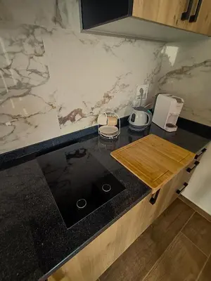 a kitchen with a marble counter top with a cutting board at 26 Steps in Calheta