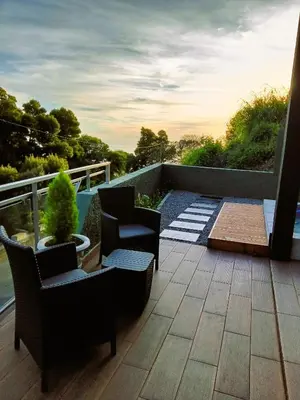 a patio with chairs and a table on a balcony at 26 Steps in Calheta