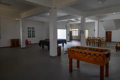 a room with a pool table in the middle of it at Holiday home with game room and entertainment in São Vicente