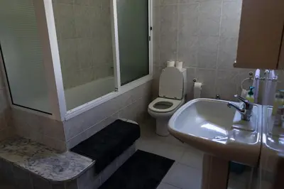 a bathroom with a sink and a toilet at Holiday home with game room and entertainment in São Vicente