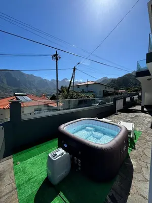 a hot tub on the roof of a house at Holiday home with game room and entertainment in São Vicente