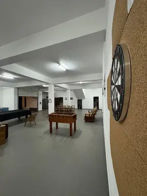 a large room with a dart board on the wall at Holiday home with game room and entertainment in São Vicente