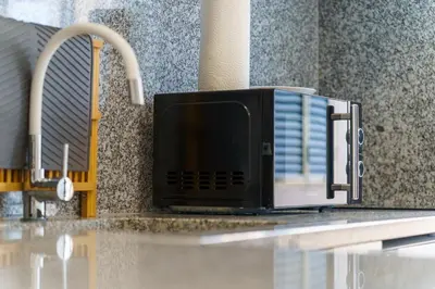 a microwave sitting on top of a kitchen counter at GuestReady – Quaint Retreat in Funchal in Funchal